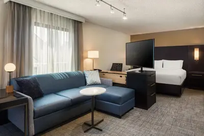 a hotel room with a couch and a bed at Residence Inn by Marriott Long Beach in Long Beach