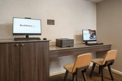 a waiting room with two chairs and a computer on a counter at Residence Inn by Marriott Long Beach in Long Beach