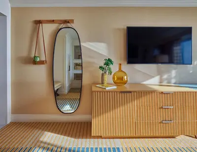 a living room with a mirror and a dresser at Viceroy Santa Monica in Los Angeles