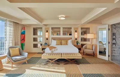 a bedroom with a king sized bed and a living room at Viceroy Santa Monica in Los Angeles