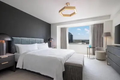 a bedroom with a large white bed and a window at JW Marriott Los Angeles L.A. LIVE in Los Angeles