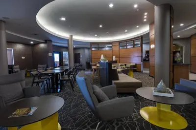 a lobby of a hotel with tables and chairs at SpringHill Suites Ridgecrest in Ridgecrest