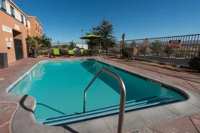 a swimming pool with a slide in the middle at SpringHill Suites Ridgecrest in Ridgecrest