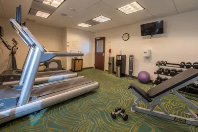 a gym with exercise equipment and a treadmill at SpringHill Suites Ridgecrest in Ridgecrest