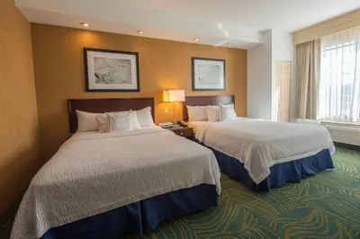 a hotel room with two beds and a window at SpringHill Suites Ridgecrest in Ridgecrest