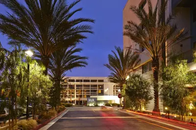 an empty street with palm trees in front of a building at Hotel MDR Marina del Rey- a DoubleTree by Hilton in Los Angeles