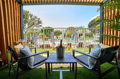 a patio with two chairs and a table and a playground at Hotel MDR Marina del Rey- a DoubleTree by Hilton in Los Angeles