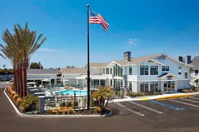 a hotel with an american flag in a parking lot at Residence Inn Los Angeles LAX/Manhattan Beach in Manhattan Beach