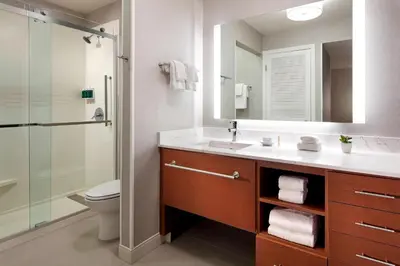 a bathroom with a sink and a shower with a mirror at Residence Inn Los Angeles LAX/Manhattan Beach in Manhattan Beach