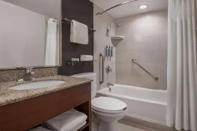 a bathroom with a sink and a toilet and a tub at Courtyard by Marriott Los Angeles Pasadena/Monrovia in Monrovia