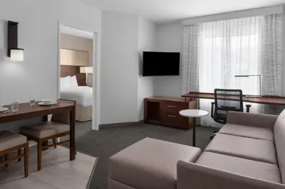 a hotel room with a couch and a bedroom at Residence Inn by Marriott Santa Clarita Valencia in Santa Clarita