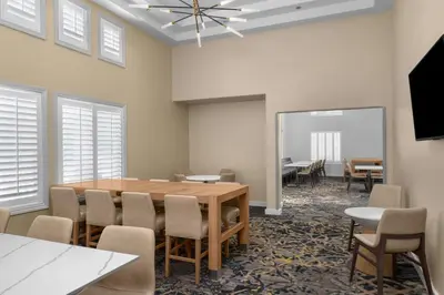 a conference room with a wooden table and chairs at Residence Inn by Marriott Santa Clarita Valencia in Santa Clarita