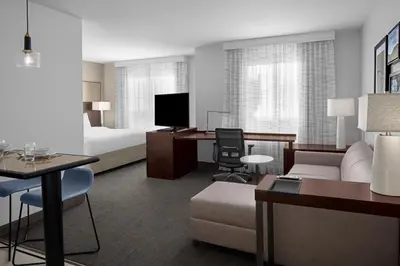 a hotel room with a bed and a living room at Residence Inn by Marriott Santa Clarita Valencia in Santa Clarita
