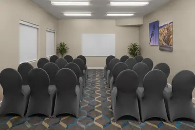 a conference room with black chairs and a whiteboard at Residence Inn by Marriott Santa Clarita Valencia in Santa Clarita
