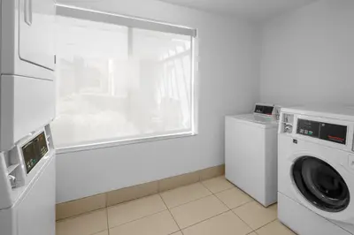 a white laundry room with a washing machine and a window at Fairfield Inn by Marriott Santa Clarita Valencia in Santa Clarita