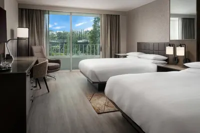 a hotel room with two beds and a desk at Warner Center Marriott Woodland Hills in Woodland Hills