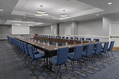 a long table and chairs in a room at Courtyard by Marriott Cypress Anaheim / Orange County in Cypress