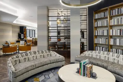 a library with two couches and a table with books at Long Beach Marriott in Long Beach