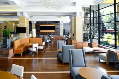 a restaurant with tables and chairs and a lobby at Long Beach Marriott in Long Beach