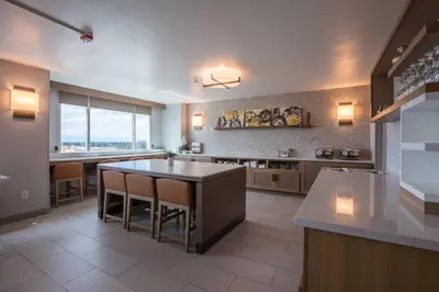 a large kitchen with a table and a large window at Bakersfield Marriott at the Convention Center in Bakersfield