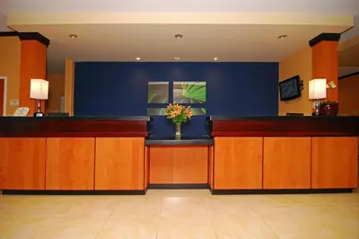 a lobby with a counter with a vase of flowers at Fairfield Inn & Suites Tehachapi in Tehachapi