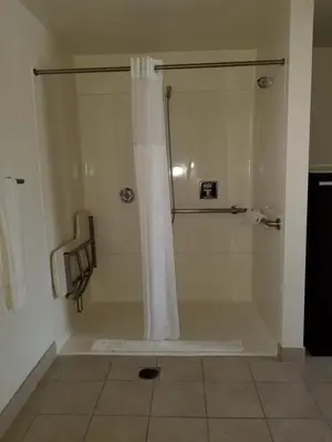 a shower with a shower curtain in a bathroom at Super 8 by Wyndham Los Angeles-Culver City Area in Los Angeles