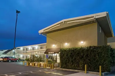 a building with a parking lot in front of it at Super 8 by Wyndham Los Angeles-Culver City Area in Los Angeles