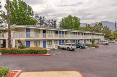 a hotel with cars parked in a parking lot at Motel 6-Arcadia, CA - Los Angeles - Pasadena Area in Arcadia