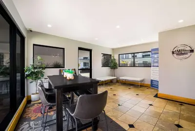 a dining room with a table and chairs at Sunset West Hotel, SureStay Collection By Best Western in Los Angeles