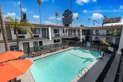 a swimming pool in front of a hotel at Sunset West Hotel, SureStay Collection By Best Western in Los Angeles