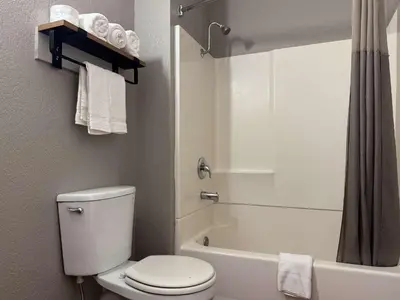 a white bathroom with a toilet and a shower at Motel 6-Simi Valley, CA in Simi Valley