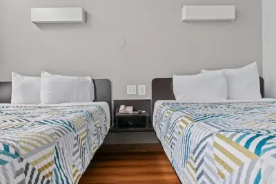two beds sitting next to each other in a room at Motel 6-Ventura, CA - Beach in Ventura