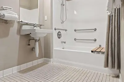 a bathroom with a shower and a sink and a tub at Motel 6-Ventura, CA - Beach in Ventura