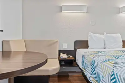 a small room with a bed and a table at Motel 6-Ventura, CA - Beach in Ventura