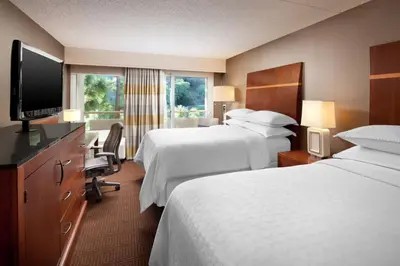 a hotel room with two beds and a flat screen tv at Sheraton Agoura Hills Hotel in Agoura Hills