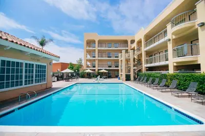a swimming pool in front of a building with chairs at Fairfield Inn Anaheim Hills Orange County in Anaheim