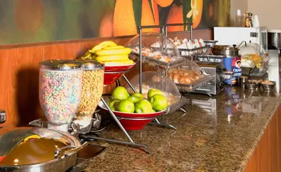 a kitchen counter with bowls of apples and other food at Fairfield Inn Anaheim Hills Orange County in Anaheim