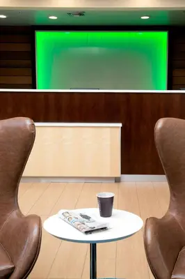 two chairs and a table in front of a screen at Fairfield Inn Anaheim Hills Orange County in Anaheim