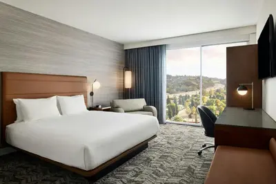 a hotel room with a bed and a large window at Courtyard Los Angeles Sherman Oaks in Sherman Oaks