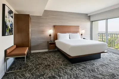 a hotel room with a large bed and a window at Courtyard Los Angeles Sherman Oaks in Sherman Oaks