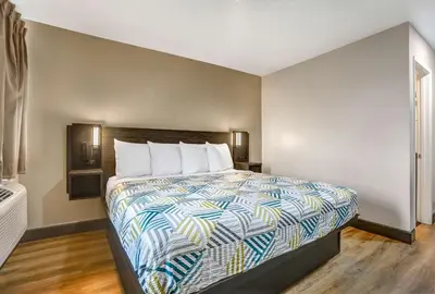 a bedroom with a bed with a colorful comforter at Motel 6-San Bernardino, CA - South in San Bernardino