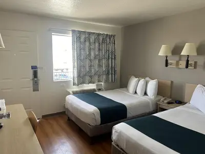 a hotel room with two beds and a window at Motel 6-Stanton, CA- Anaheim West in Stanton
