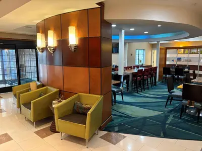 a dining room with chairs and tables in a restaurant at Best Western Hesperia-Victorville Suites in Hesperia