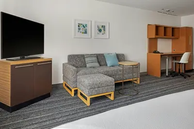 a living room with a couch and a flat screen tv at TownePlace Suites by Marriott Ontario Airport in Rancho Cucamonga