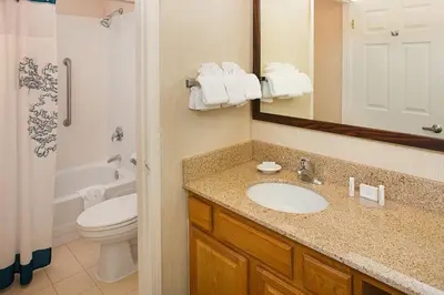 a bathroom with a sink and a toilet and a mirror at Residence Inn by Marriott Ontario Airport in Ontario