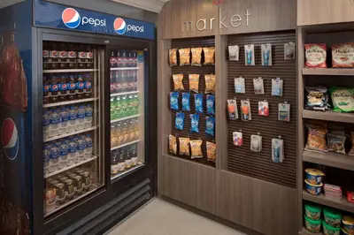 a grocery store aisle with a drink refrigerator at Residence Inn by Marriott Ontario Airport in Ontario