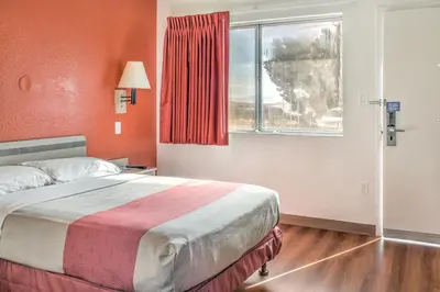 a bedroom with a large bed and a window at Motel 6-Mojave, CA in Mojave