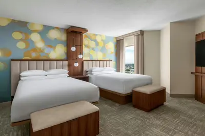 a hotel room with two beds and a television at Anaheim Marriott Suites in Anaheim