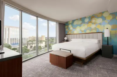 a hotel room with a bed and large windows at Anaheim Marriott Suites in Anaheim