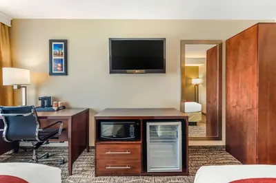 a hotel room with a desk and a tv at Comfort Inn Monterey Park - Los Angeles in Monterey Park